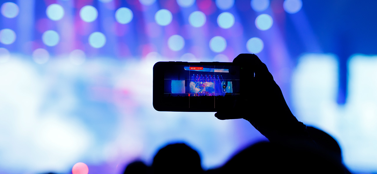 Someone recording live music on their phone.